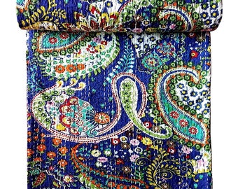 May include: A blue kantha quilt with a paisley pattern in shades of green, orange, red, and white. The quilt is hand-stitched and has a traditional Indian design.
