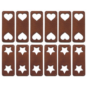 May include: Ten brown leather bookmarks with cut-out shapes. Five bookmarks have a heart shape cut-out and five bookmarks have a star shape cut-out.