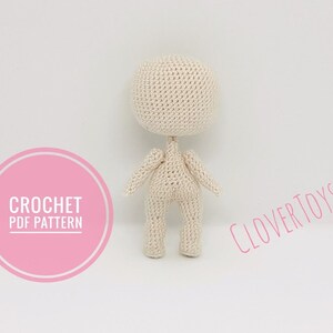 May include: A crochet doll pattern, with the text "CROCHET PDF PATTERN" and "CLOVERTOYS" on the image.