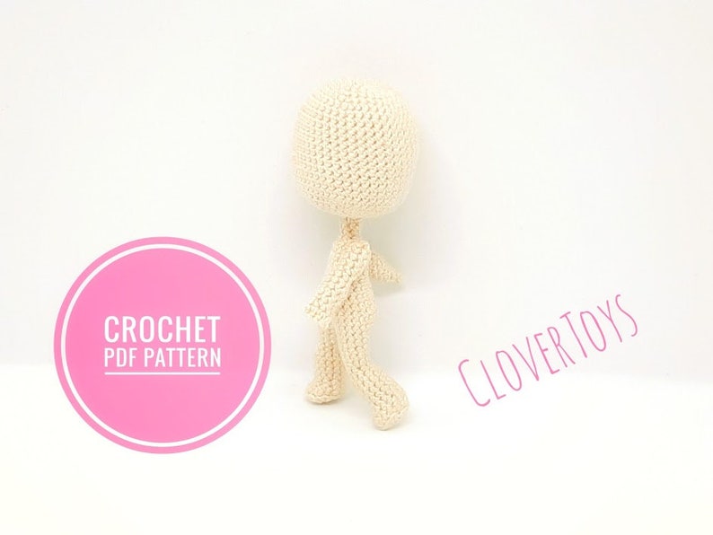 May include: A crochet pattern for a small, beige, amigurumi doll. The pattern is available as a PDF download. The image shows the doll standing on a white background. The text "CROCHET PDF PATTERN" is on a pink circle in the lower left corner of the image. The text "CLOVERTOYS" is in the upper right corner of the image.