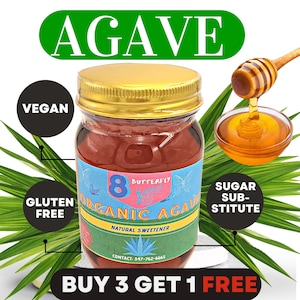 May include: A glass jar of organic agave nectar with a gold lid. The label is green and blue with the text "8 Butterfly Organic Agave Natural Sweetener" and a contact number. The jar is sitting on a white surface with green leaves in the background. The text "Buy 3 Get 1 Free" is at the bottom of the image.