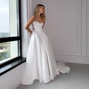 Satin Wedding Dress with Corset Bodice and Dropped Basque Waist – Strapless A-line Gown with Train