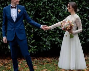 Kanten trouwjurk: lange mouwen, theelange rok, romantische bruidsjurk