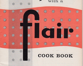 May include: A vintage cookbook cover with the title "Foods with a Flair" in black script. The design features a red and grey dotted pattern, with the word "flair" in large, bold letters. The cover also includes the text "COOK BOOK".