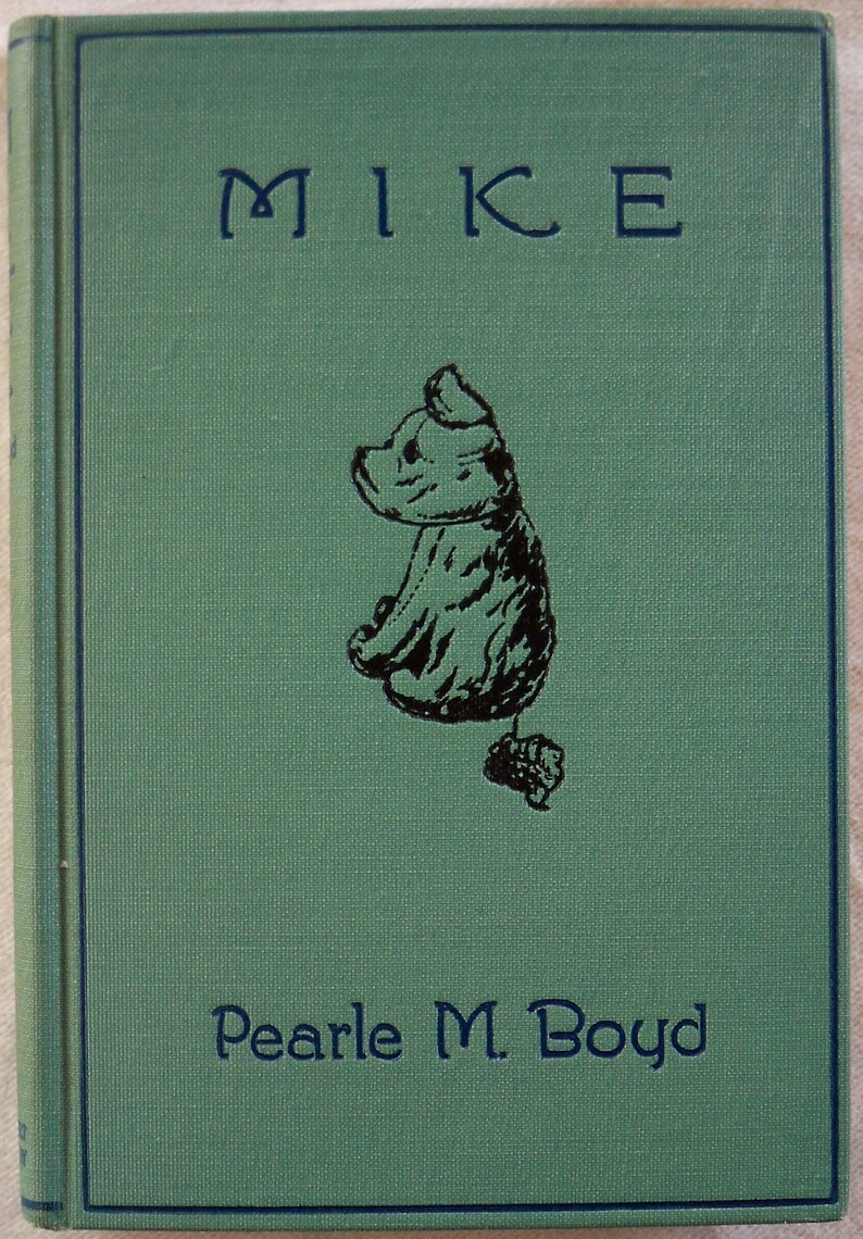 May include: A green book with the title "MIKE" in black lettering and the author "Pearle M. Boyd" in black lettering. A black and white illustration of a small bear wearing a hat is on the front cover.