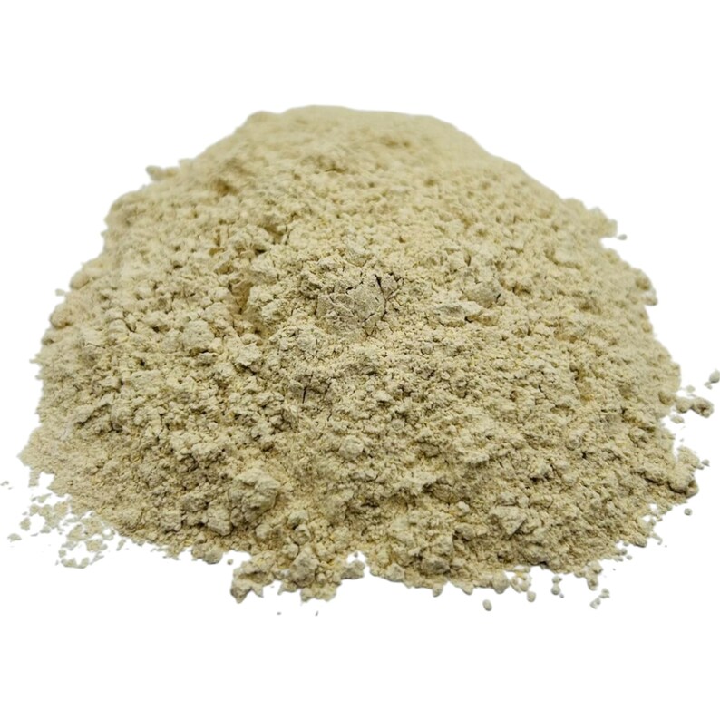May include: A close-up of a pile of light beige ground ginger powder.