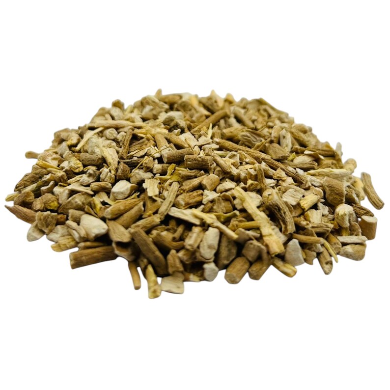 May include: A pile of chopped, dried, tan-colored roots. The pieces vary in size and shape, with some appearing more like small sticks and others more like irregular chunks. The background is plain white, highlighting the natural color of the roots.