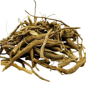 May include: A pile of dried, light brown valerian root pieces. The roots vary in size and shape, with some having a more fibrous appearance. The background is plain white, highlighting the natural color and texture of the roots.