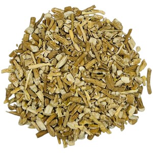 May include: A close-up shot of a pile of dried, chopped plant roots. The pieces vary in size and shape, with a mix of light tan and brown hues. The texture appears rough and fibrous, suggesting a natural, unprocessed product.