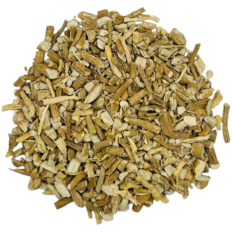 May include: A close-up shot of a pile of dried, chopped plant roots. The pieces vary in size and shape, with a mix of light tan and brown hues. The texture appears rough and fibrous, suggesting a natural, unprocessed product.