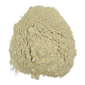 May include: A close-up of a pile of light beige, finely ground powder. The powder is smooth and uniform in texture.