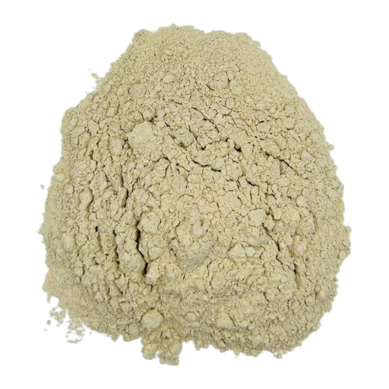 May include: A close-up of a pile of light beige, finely ground powder. The powder is smooth and uniform in texture.