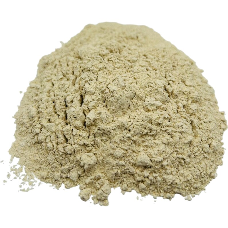 May include: A close-up of a pile of light beige powder. The powder is finely ground and has a slightly rough texture.