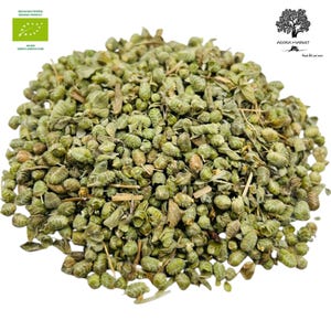 May include: A close-up of a pile of dried green oregano leaves. The oregano is organic and comes from Greece. The label says "Biologico", "Organic Product", and "Greek Agriculture".