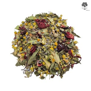 May include: A loose leaf herbal tea blend consisting of dried yellow chamomile flowers, deep red hibiscus petals, small purple lavender buds, and various green dried leaves and herbs, all mixed together in a textured, organic pile.