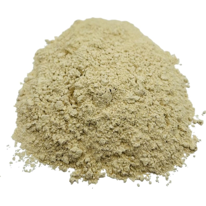 May include: A close-up of a pile of light beige powder. The powder is finely ground and has a slightly grainy texture.