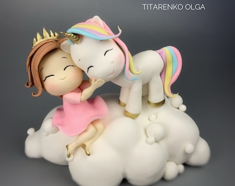 May include: A white unicorn with a rainbow mane and tail is hugging a girl with brown hair wearing a pink dress and a gold crown. They are both sitting on a white cloud with gold accents.