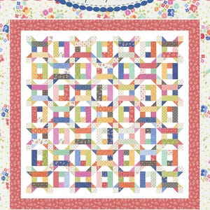 May include: A quilt pattern called "#216 Jelly Roll Jackpot" from the "Coriander Quilts" collection by Corey Yoder. The quilt is made with a jelly roll of fabric and features a colorful patchwork design with a white background.