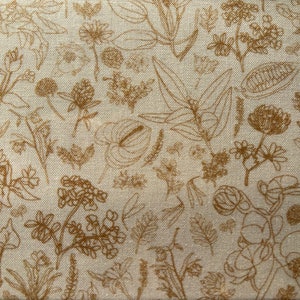 May include: A white fabric with a brown floral pattern. The pattern features various types of flowers and leaves, all outlined in brown.