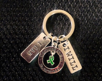 May include: Silver keychain with a green ribbon and the words "Cerebral Palsy Awareness", "I CAN", and "I WILL".