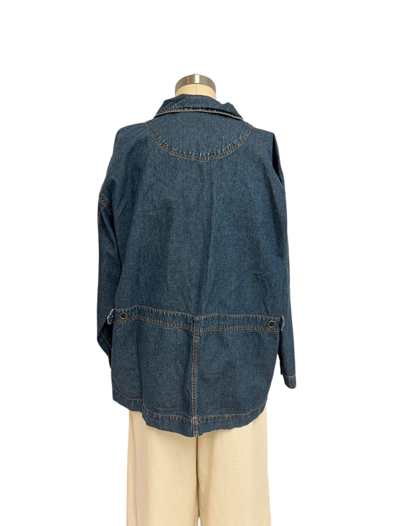 May include: A blue denim jacket with a button-up front and long sleeves. The jacket has a collar and two pockets on the front.
