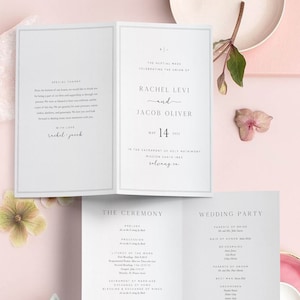 Może przedstawiać: Program ceremonii ślubnej z białym tłem i czarnym tekstem. Program zawiera imiona panny młodej i pana młodego, Rachel Levi i Jacob Oliver, datę ślubu, 14 maja 2022 roku, oraz miejsce, Mission Santa Ines, Solvang, CA. Program zawiera również kolejność ceremonii, gości weselnych i specjalne podziękowania.