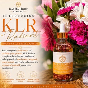 May include: A clear glass bottle of KLR Radiant Solar Plexus Chakra Body Oil with a gold dropper, set against a backdrop of pink and white flowers. The label reads "KLR Radiant" and "Solar Plexus Chakra Body Oil."