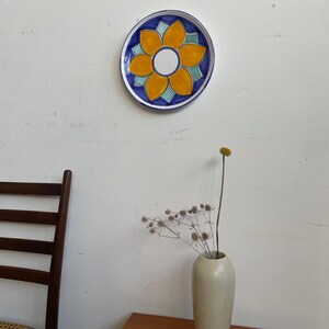 Decorative hand painted Italian wall plate yellow flower and blue surround