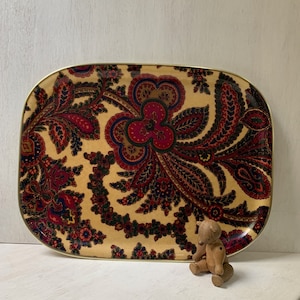 May include: A vintage rectangular serving tray with a gold rim and a paisley pattern in shades of red, blue, green, and black on a cream background.