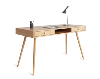 May include: A light wood desk with two drawers and a shelf. The desk has a lamp on the right side and a pencil holder on the left side.
