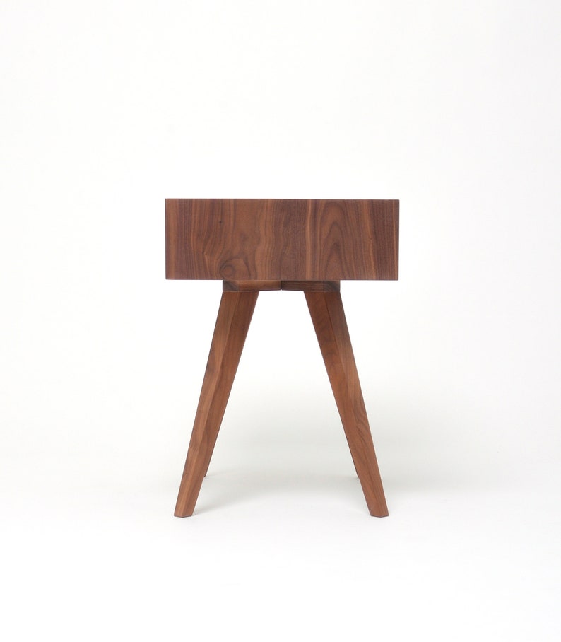 May include: A dark brown wooden side table with a square top and four angled legs.