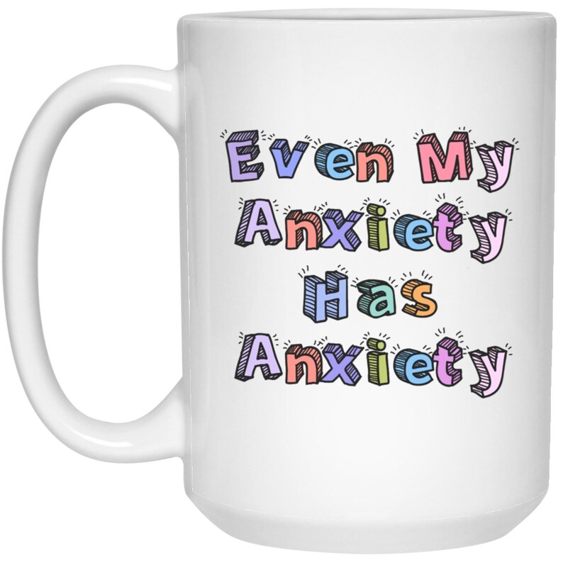 May include: White ceramic mug with a colorful design that reads "Even My Anxiety Has Anxiety".