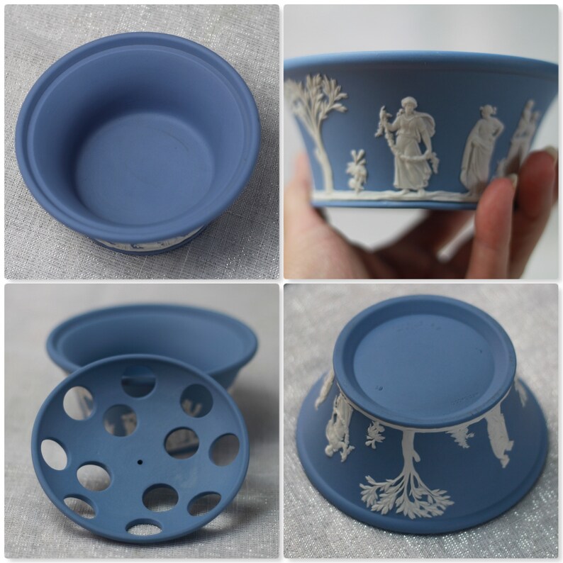 May include: A set of blue ceramic bowls with white relief designs. The bowls have a classic, elegant look, with detailed figures and scenes. The set includes a bowl, a lid with holes, and a base. The bowls are likely for decorative or serving purposes.