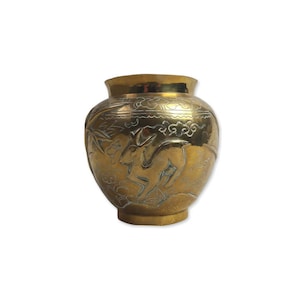 May include: A gold-coloured, round vase with an etched design. The vase features a deer and floral pattern. The vase has a wide body and a narrow neck. The vase is made of metal and has a shiny finish.