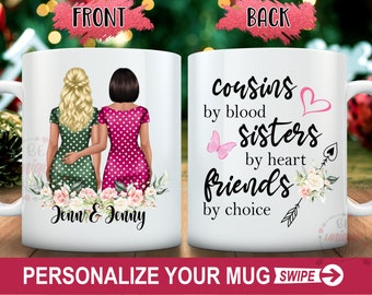 Könnte beinhalten: Weiße Keramik-Tasse mit zwei Frauen in gepunkteten Kleidern und dem Text "Jenn & Jenny" darunter. Auf der Rückseite der Tasse steht "cousins by blood, sisters by heart, friends by choice".