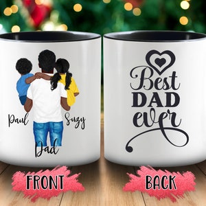 May include: White ceramic mug with a black interior and handle. The front features a graphic of a father holding two children, with the names "Paul" and "Suzy" below. The back of the mug says "Best DAD ever" in black script.