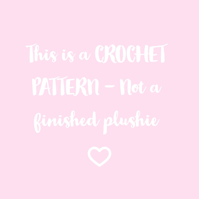 May include: A pink background with white text that reads "This is a CROCHET PATTERN - Not a finished plushie" with a white heart at the bottom.