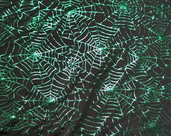 Halloweentyg: Grönt folierat spindelnät på svart stretchtyg