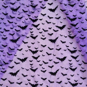 May include: Purple sheer fabric with a black bat pattern. The bats are scattered randomly across the fabric.