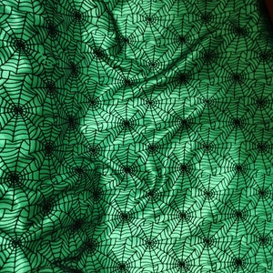 Halloween fabric Black spider web  flocking on green stain  by the yard