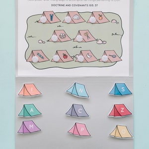 May include: A printable activity for kids featuring a camping theme. The activity includes a sheet with tents and various objects inside each tent. A second sheet has tents with letters on them. The goal is to match the letters to the objects in the tents.