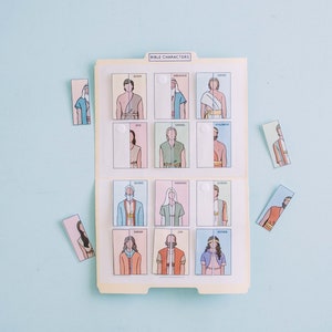 May include: A vintage-style educational game featuring illustrated Bible characters. The game includes a file folder with character cards and individual puzzle pieces. The title "BIBLE CHARACTERS" is printed on the folder.