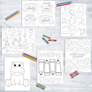 May include: A collection of black and white coloring pages featuring school buses, school supplies, donuts, and other fun images. Crayons and colored pencils are scattered around the pages. The text "Looking Sharp" is visible.
