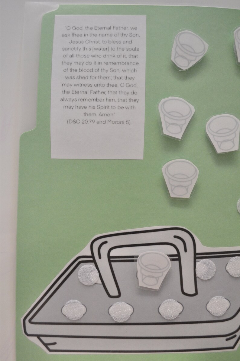 May include: A green and white paper craft with a quote from the Book of Mormon about the sacrament. The quote reads, "O God, the Eternal Father, we ask thee in the name of thy Son, Jesus Christ, to bless and sanctify this [water] to the souls of all those who drink of it, that they may do it in remembrance of the blood of thy Son, which was shed for them, that they may witness unto thee, O God, the Eternal Father, that they do always remember him, that they may have his Spirit to be with them. Amen" (D&C 20.79 and Moroni 5).