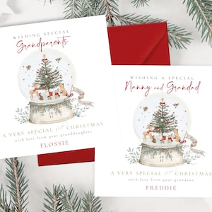 May include: Two Christmas cards with red envelopes. One card says "Wishing Special Grandparents" and the other says "Wishing Special Nanny and Grandad." Both cards feature a snow globe with a Christmas tree and the text "A Very Special Christmas."