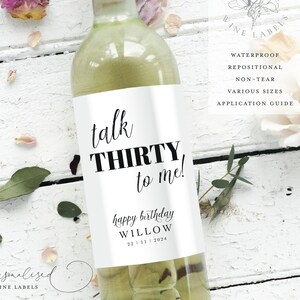 May include: A white wine bottle with a black and white label that says "talk THIRTY to me!" and "happy birthday WILLOW 22/11/2024".