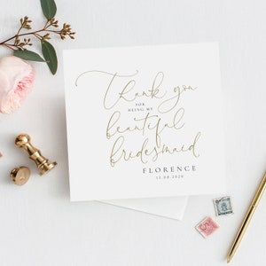 May include: A white card with gold calligraphy that reads "Thank you for being my beautiful bridesmaid." The card also includes the name "Florence" and the date "12.08.2020".