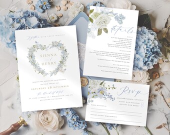 May include: Wedding invitation suite featuring a heart-shaped floral design with the names "Sienna" and "Henry". The suite includes an invitation, details card, and RSVP card, all with blue floral accents. The text includes the date, location, and RSVP information.