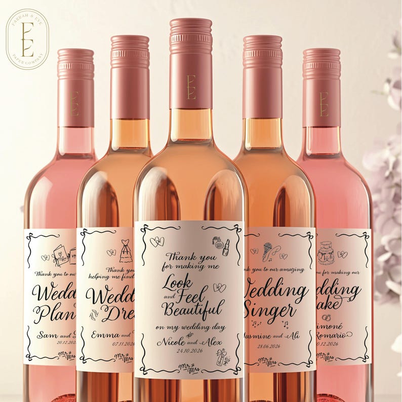 May include: Five glass wine bottles filled with rose-colored liquid, each featuring a custom rectangular label with black text and line art illustrations. The central label reads: Thank you for making me Look and Feel Beautiful on my wedding day.