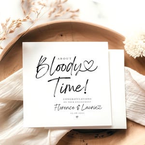 Peut inclure: Une carte blanche avec du texte noir qui dit "About Bloody Time! Félicitations pour vos fiançailles Florence & Laurie 23.06.2023".
